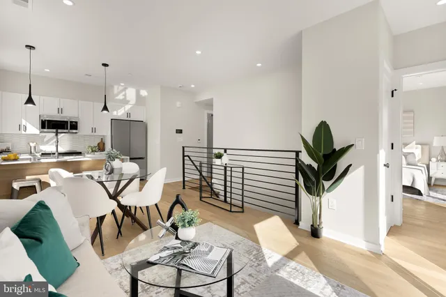 a living room with furniture a dining table and kitchen view