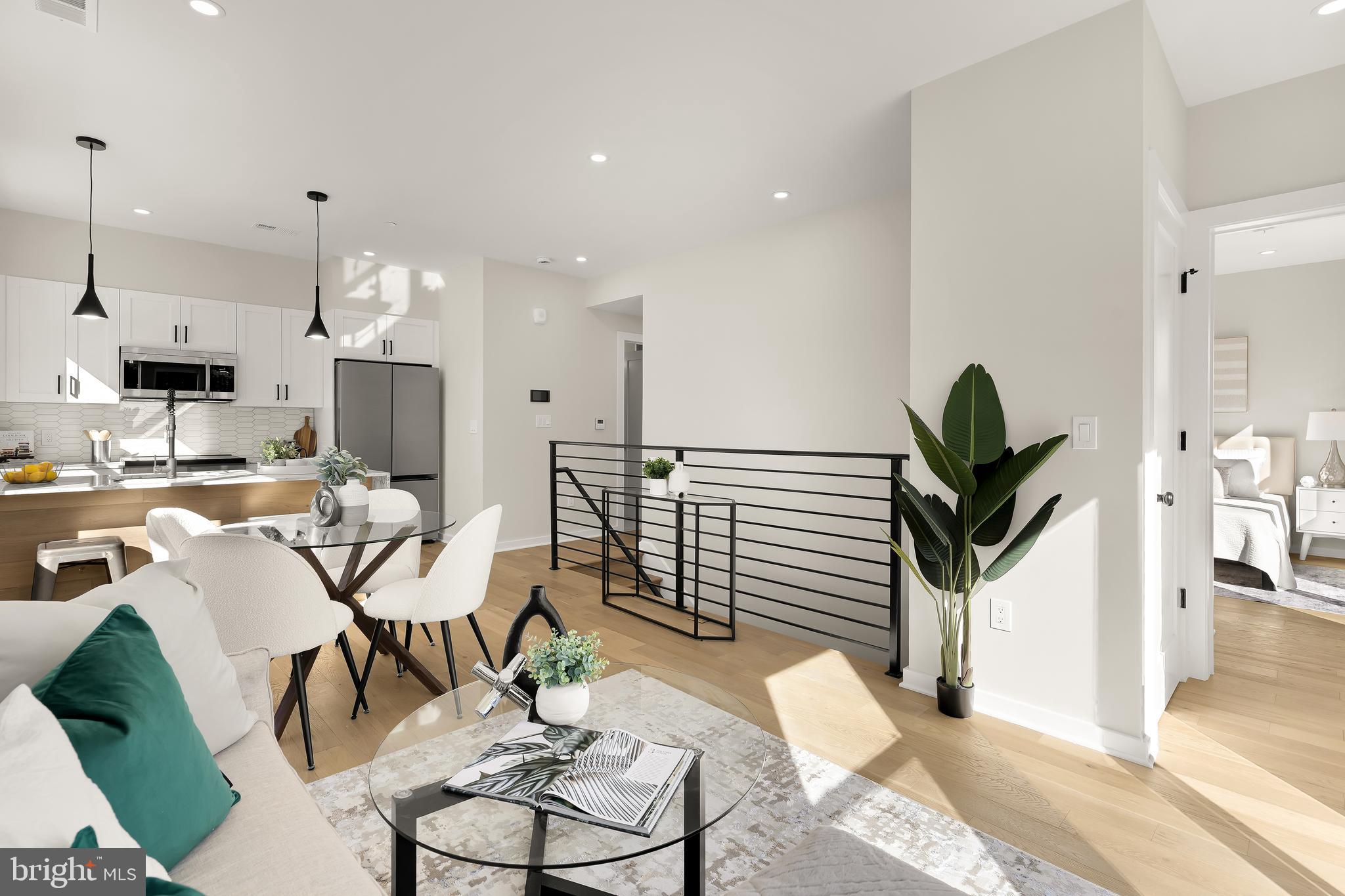 2606 41st Street Northwest, Unit PH Washington, DC 20007 - Photo 4 of 29 a living room with furniture a dining table and kitchen view