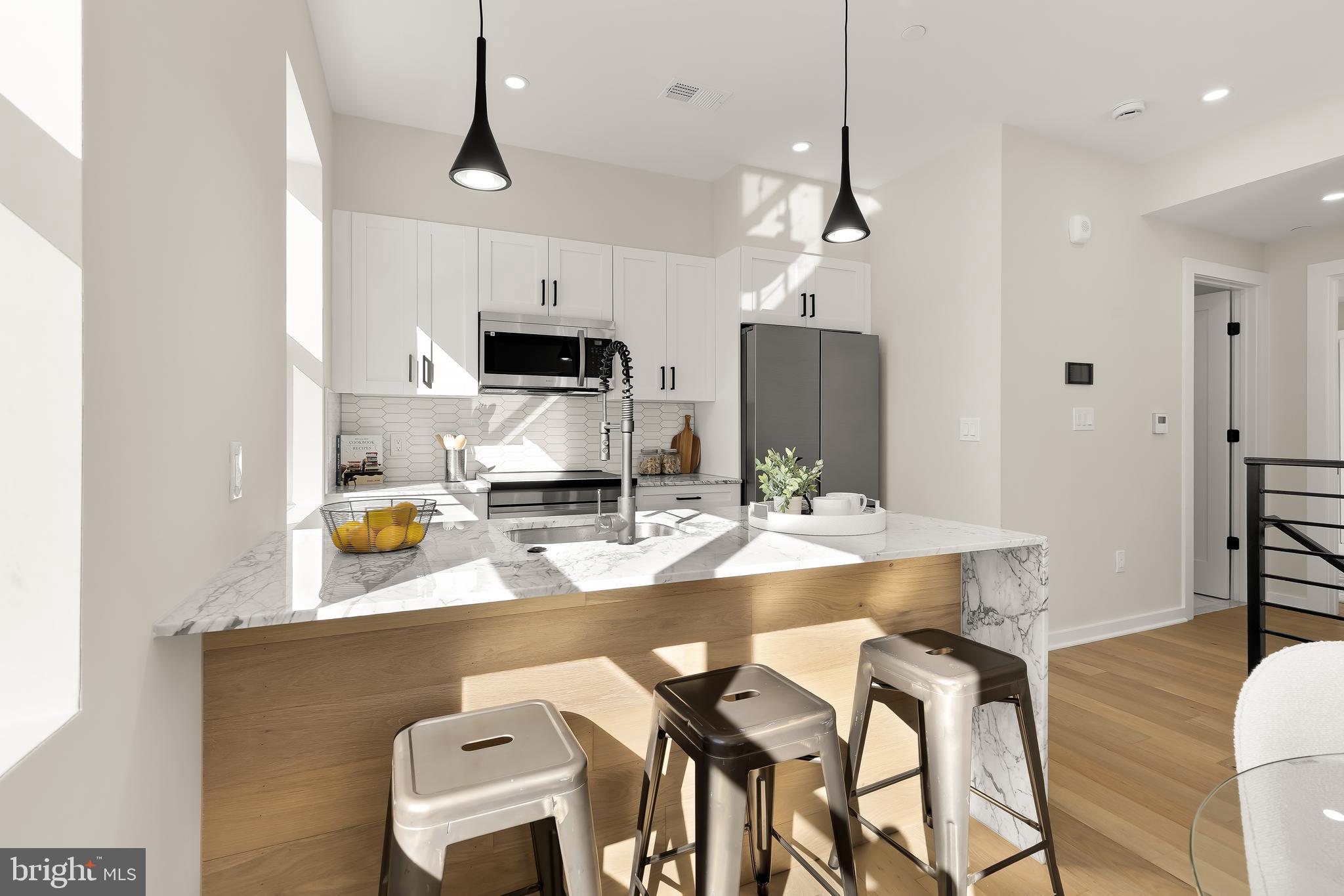 2606 41st Street Northwest, Unit PH Washington, DC 20007 - Photo 8 of 29 a kitchen with kitchen island granite countertop a sink and a stove