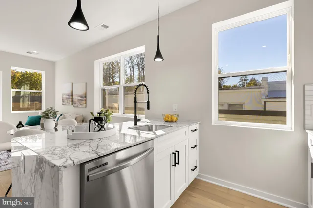 a kitchen with stainless steel appliances granite countertop a sink and a window
