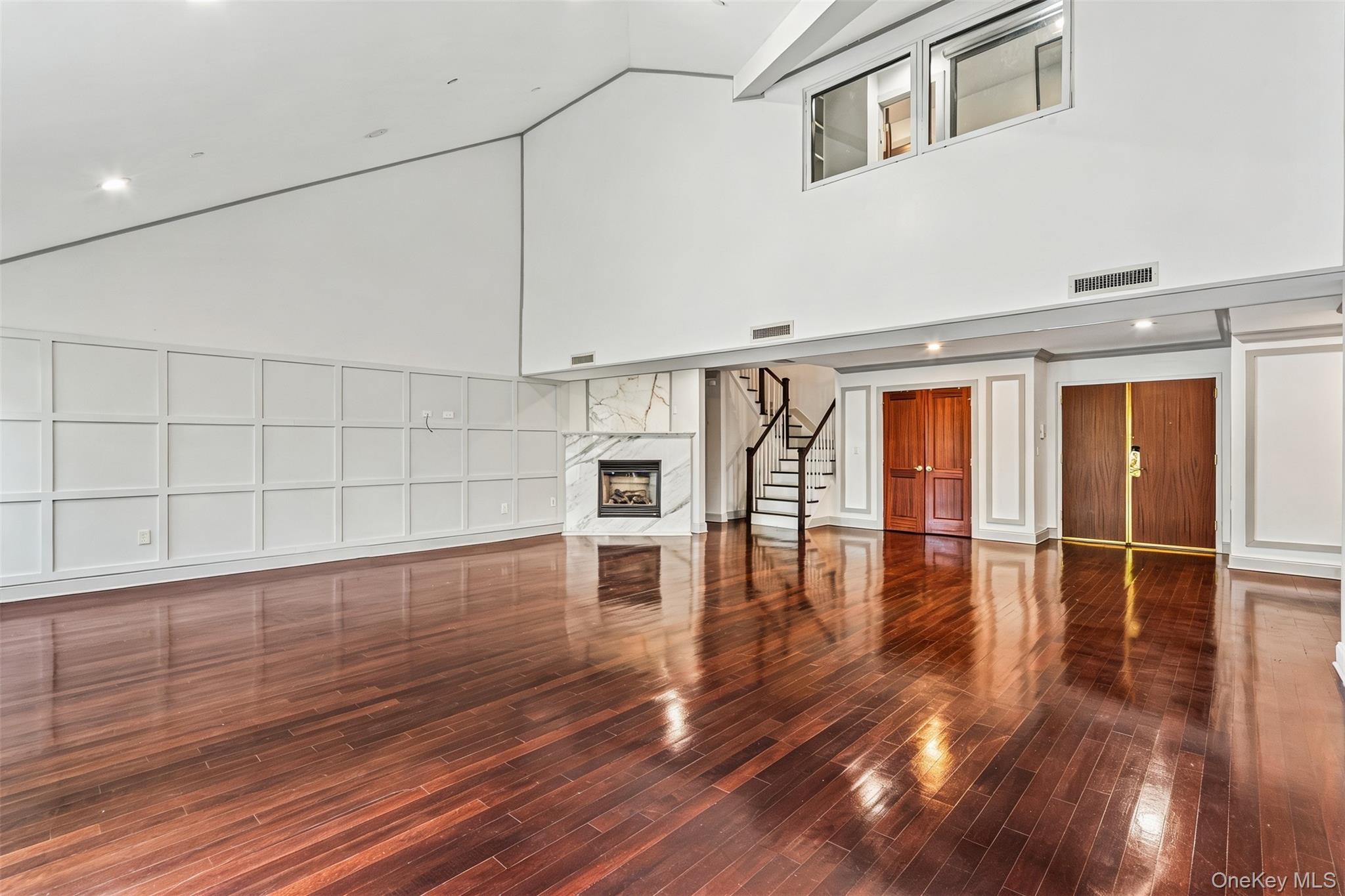 171 Great Neck Road, Unit 4R Great Neck, NY 11021 - Photo 2 of 27 a view of empty room with wooden floor and fan