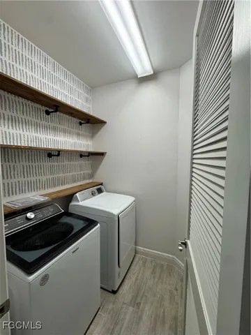 a view of storage and utility room with washer and dryer
