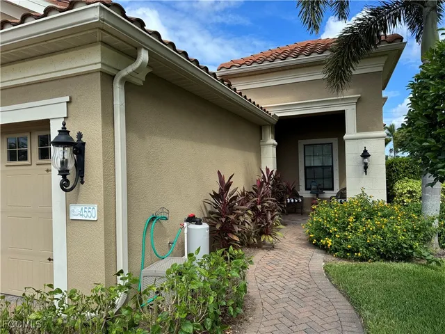 a front view of a house with potted plants