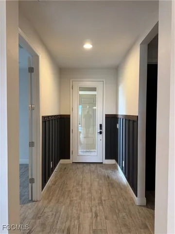 a view of a hallway with wooden walls