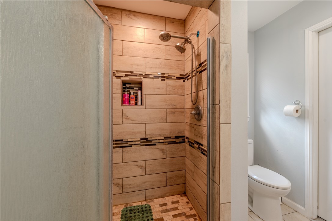 1201 Devon Drive Corpus Christi, TX 78404 - Photo 11 of 23 a bathroom with a shower toilet and sink
