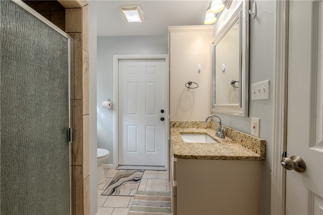 1201 Devon Drive Corpus Christi, TX 78404 - Photo 12 of 23 a bathroom with a granite countertop sink and a mirror