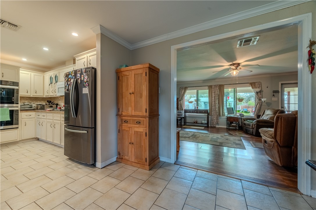 1201 Devon Drive Corpus Christi, TX 78404 - Photo 5 of 23 a kitchen with stainless steel appliances granite countertop a refrigerator and a sink