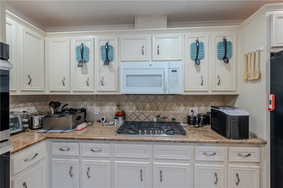 1201 Devon Drive Corpus Christi, TX 78404 - Photo 7 of 23 a kitchen with white cabinets and sink