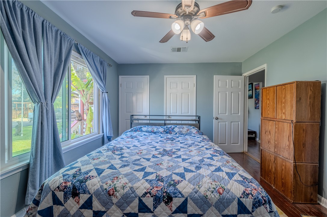 1201 Devon Drive Corpus Christi, TX 78404 - Photo 10 of 23 a bedroom with a bed and a chandelier