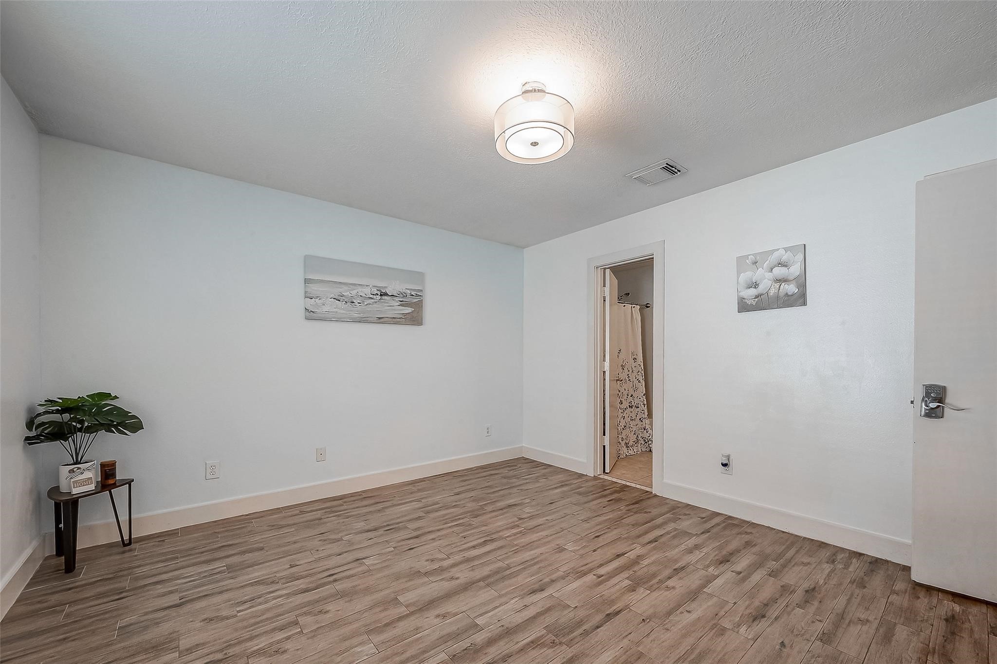 9511 Farrell Drive Houston, TX 77070 - Photo 14 of 28 a view of a room with wooden floor and a potted plant