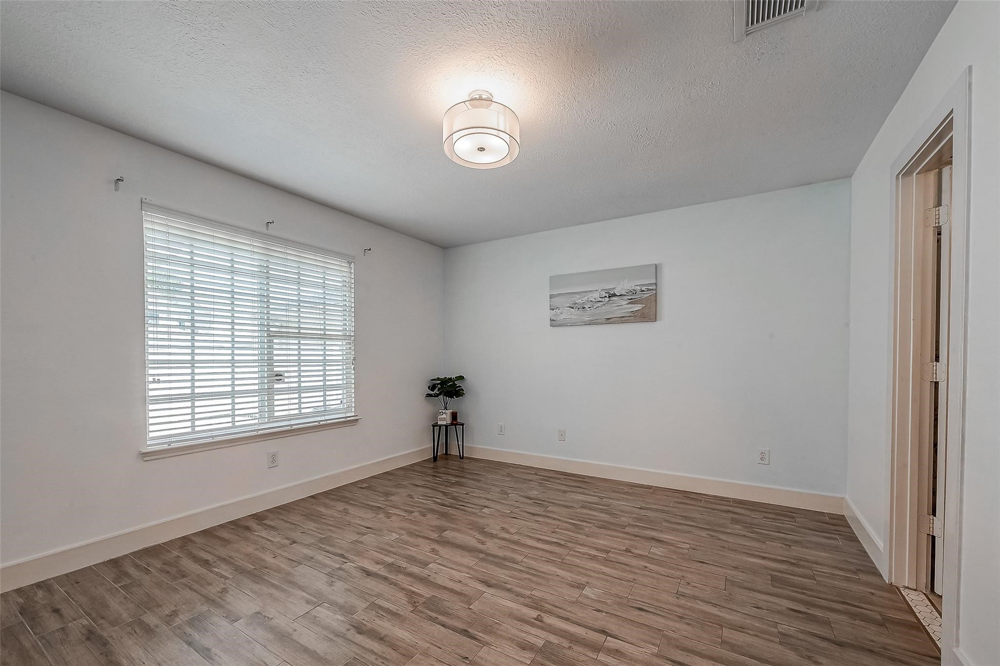 9511 Farrell Drive Houston, TX 77070 - Photo 15 of 28 a view of empty room with wooden floor and fan