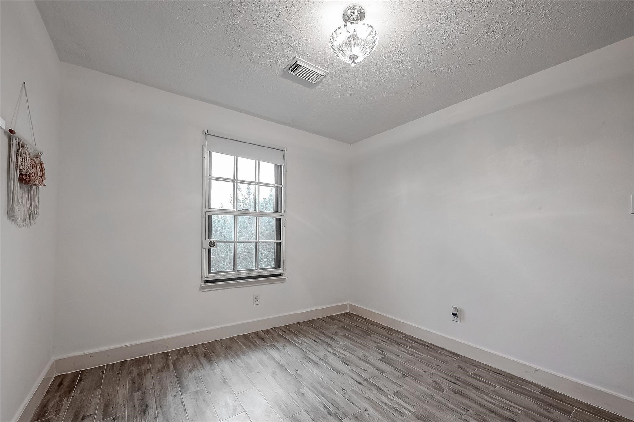 9511 Farrell Drive Houston, TX 77070 - Photo 19 of 28 wooden floor and window in an empty room