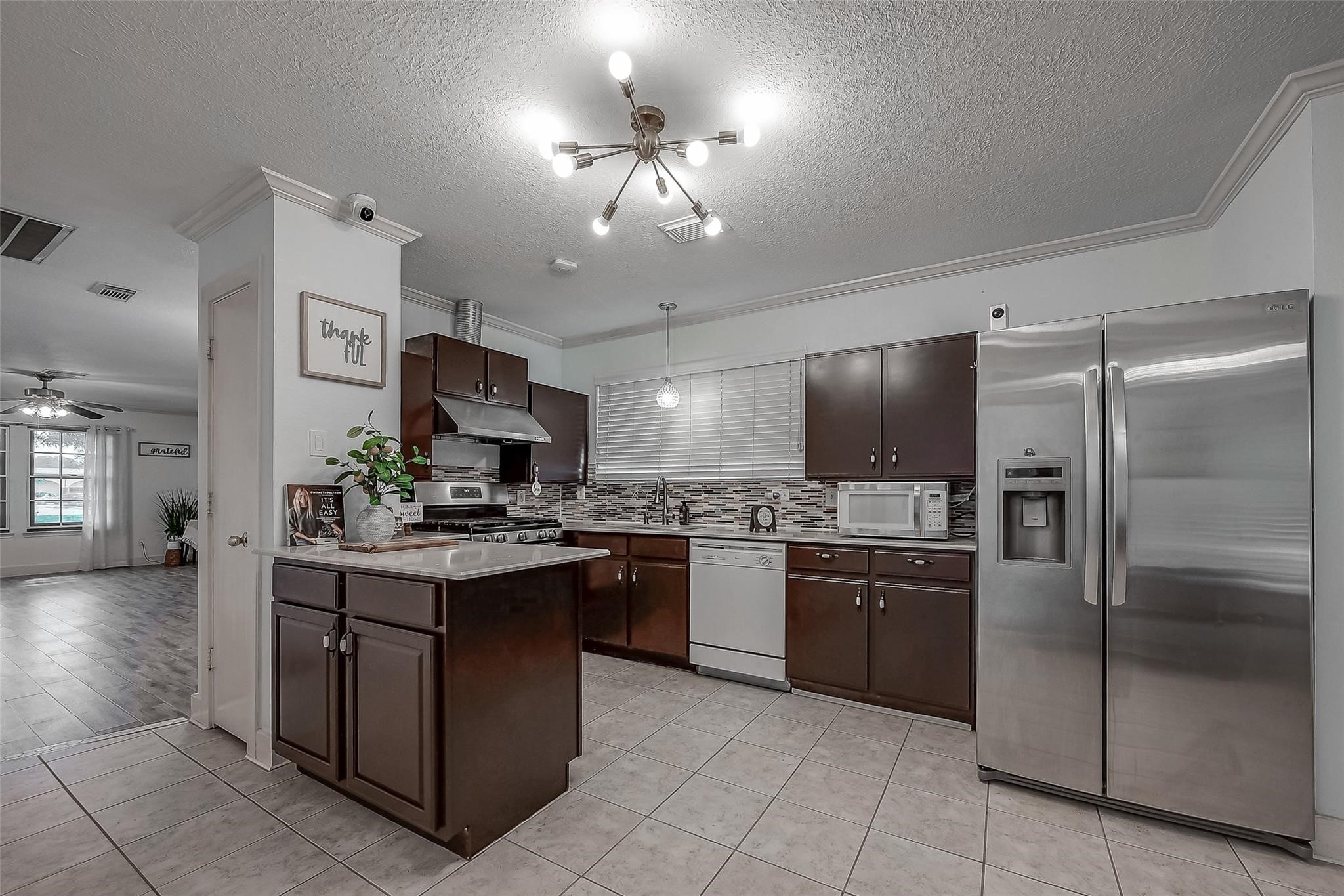 9511 Farrell Drive Houston, TX 77070 - Photo 7 of 28 a kitchen with stainless steel appliances granite countertop a stove refrigerator and a sink
