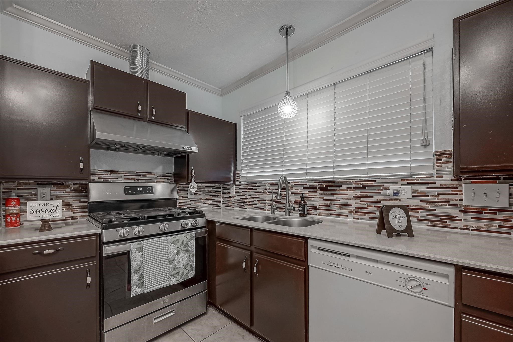9511 Farrell Drive Houston, TX 77070 - Photo 10 of 28 a kitchen with stainless steel appliances a sink stove and cabinets