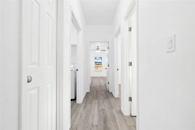 a view of a hallway with wooden floor