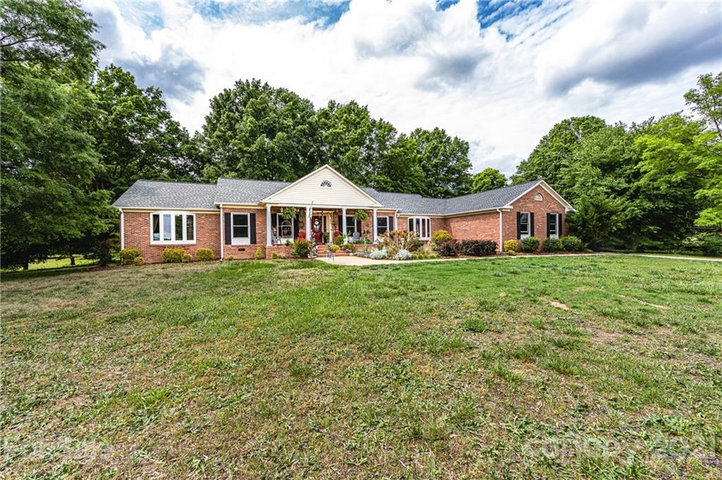 515 Windy Hill Road York, SC 29745 - Photo 1 of 45 a house view with swimming pool and garden space