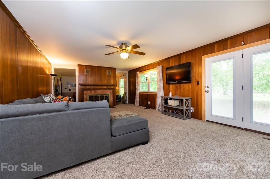 515 Windy Hill Road York, SC 29745 - Photo 15 of 45 a living room with furniture a fireplace and a flat screen tv