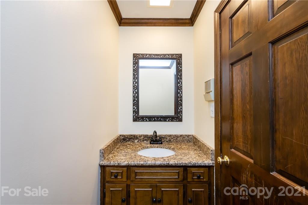 515 Windy Hill Road York, SC 29745 - Photo 27 of 45 a bathroom with a granite countertop sink and a mirror