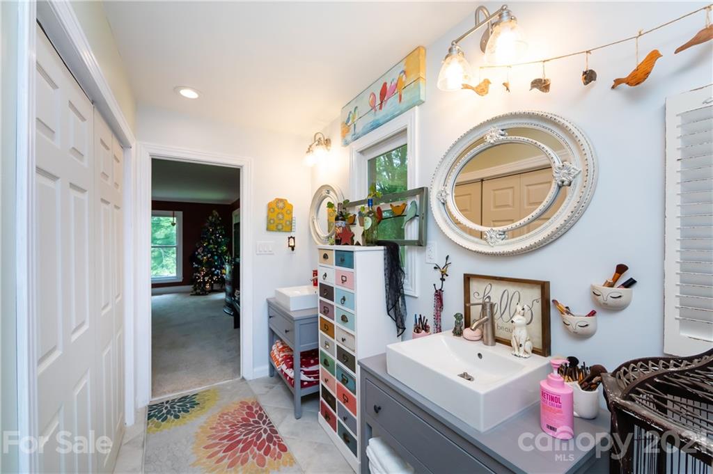 515 Windy Hill Road York, SC 29745 - Photo 31 of 45 a bedroom with a bed and a chandelier