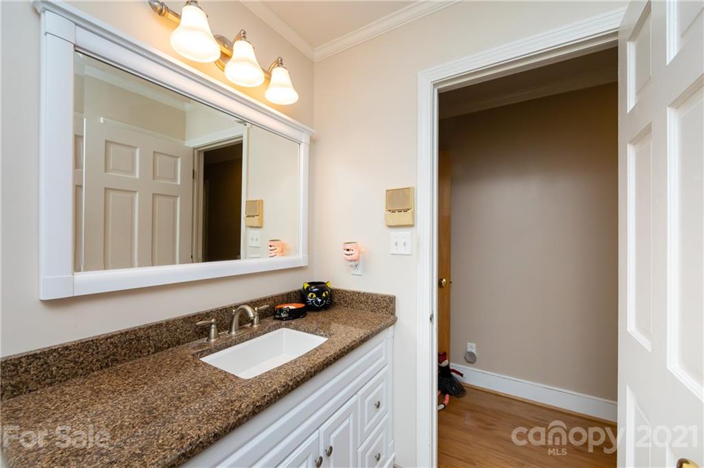 515 Windy Hill Road York, SC 29745 - Photo 36 of 45 a bathroom with a granite countertop sink and a mirror