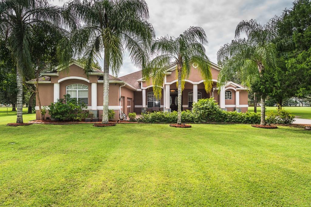 13303 Lewis Raulerson Road Dover, FL 33527 - Photo 1 of 1 a front view of house with yard and green space