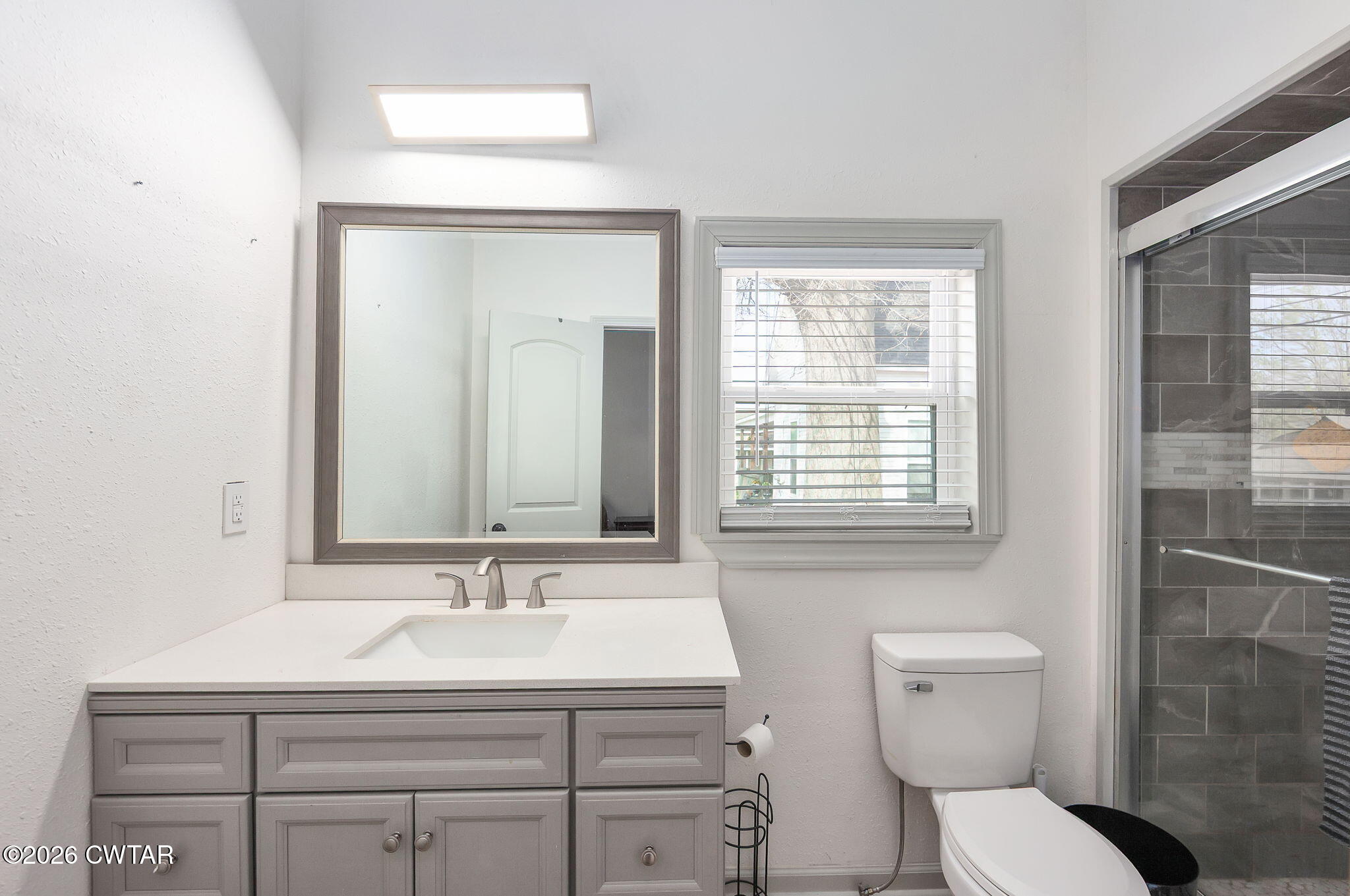 209 Hatton Street Jackson, TN 38301 - Photo 11 of 20 a bathroom with a toilet sink and mirror