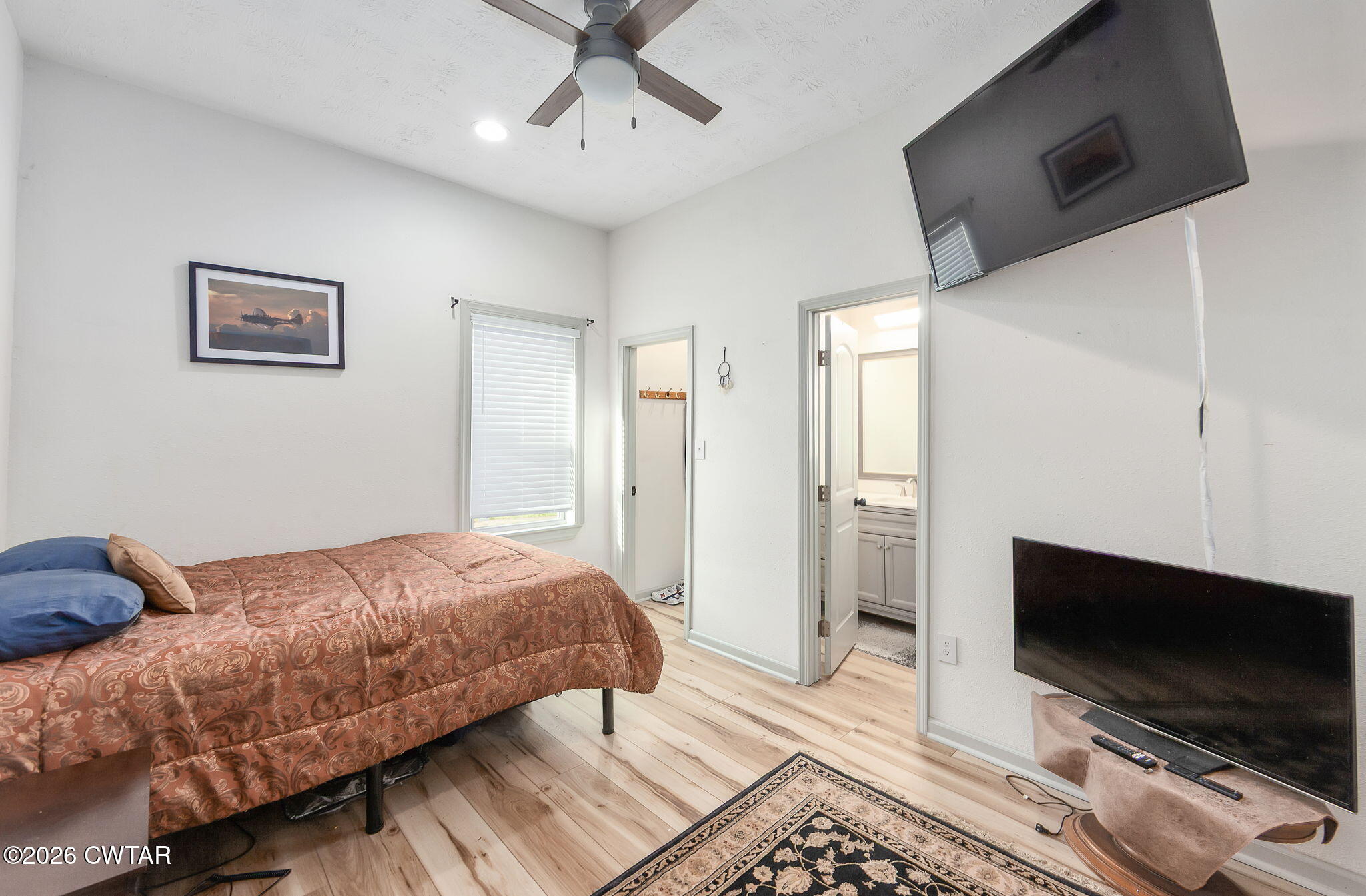 209 Hatton Street Jackson, TN 38301 - Photo 13 of 20 a bedroom with a bed and a flat screen tv