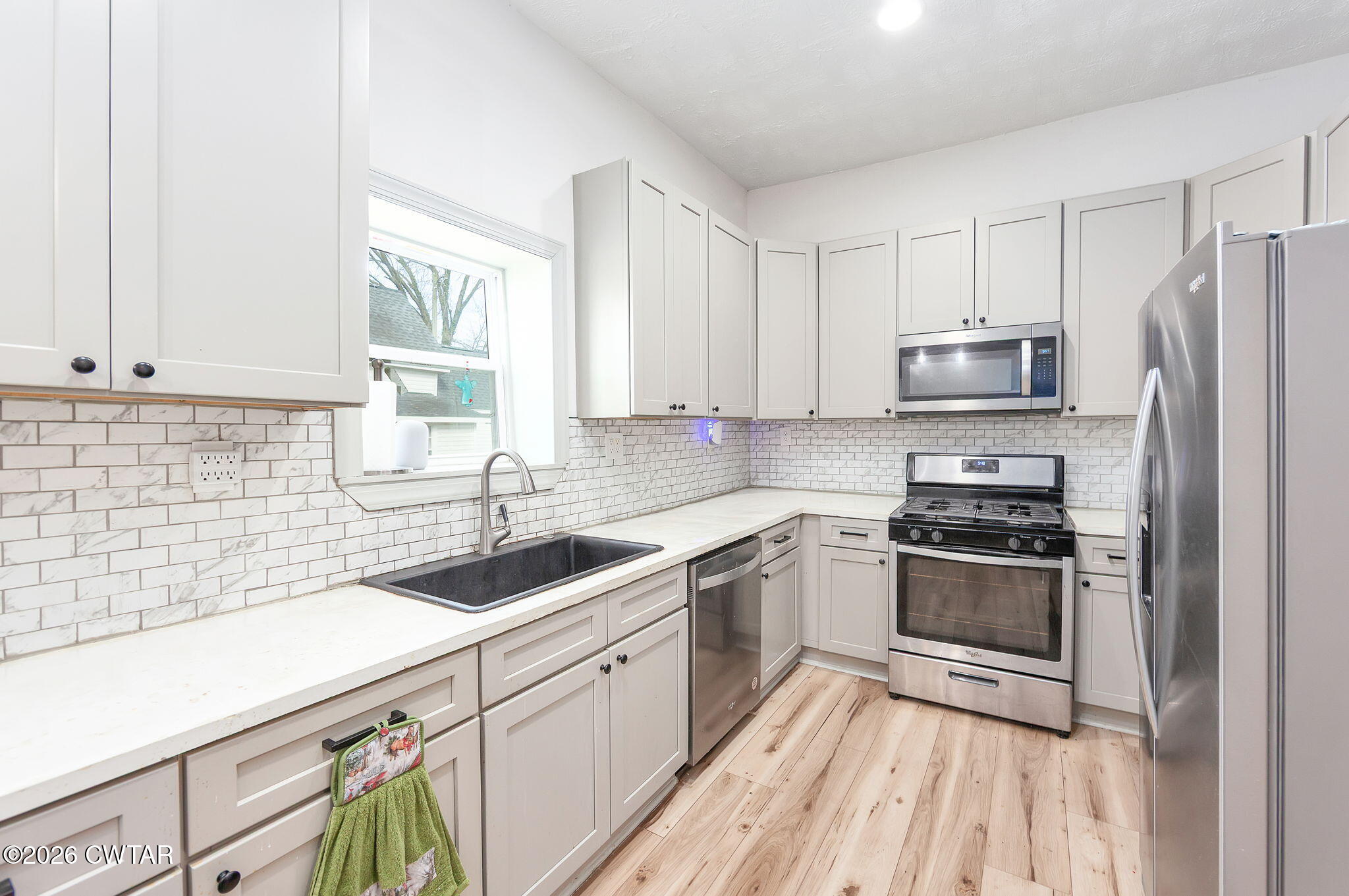 209 Hatton Street Jackson, TN 38301 - Photo 8 of 20 a kitchen with a sink stove and refrigerator