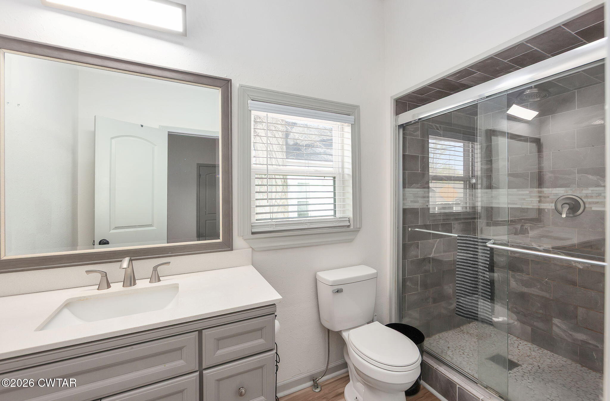 209 Hatton Street Jackson, TN 38301 - Photo 10 of 20 a bathroom with a sink toilet vanity and shower
