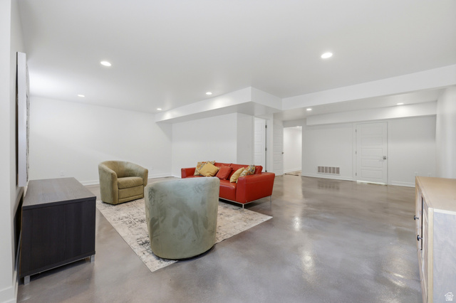 1389 Millbrook Way Bountiful, UT 84010 - Photo 47 of 74 Spacious lower-level room featuring polished concrete flooring, recessed lighting, and crisp white walls