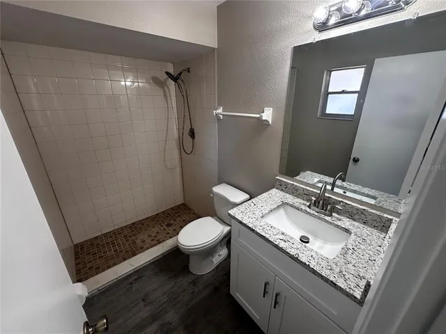 a bathroom with a sink toilet and shower