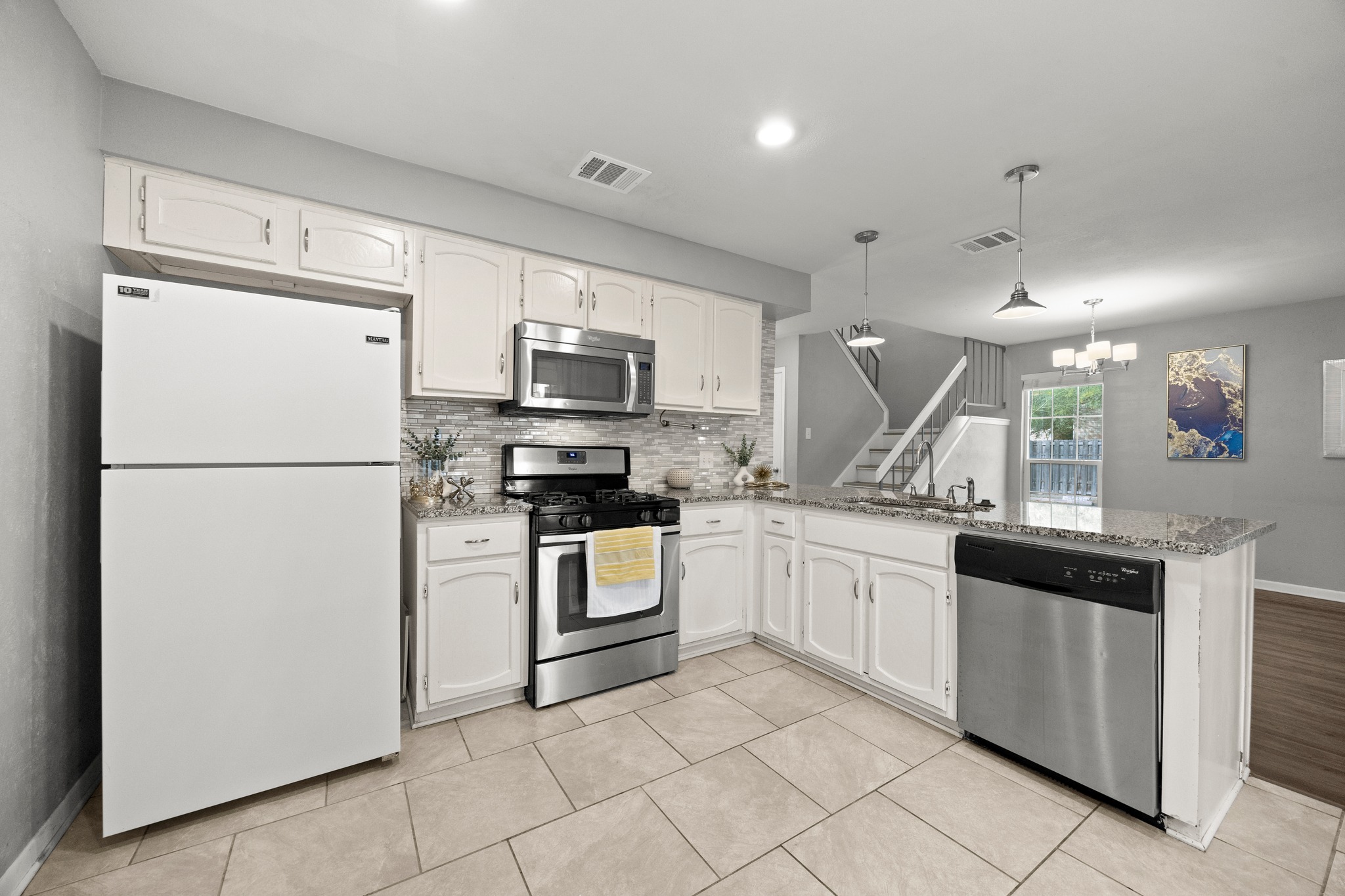 8330 Fathom Circle, Unit 501 Austin, TX 78750 - Photo 8 of 26 a kitchen with white cabinets and white appliances