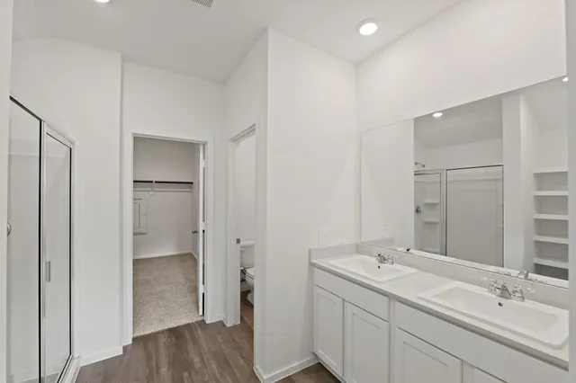 a bathroom with a double vanity sink and mirror