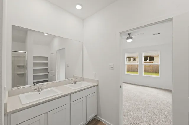 a bathroom with a sink double vanity and a mirror