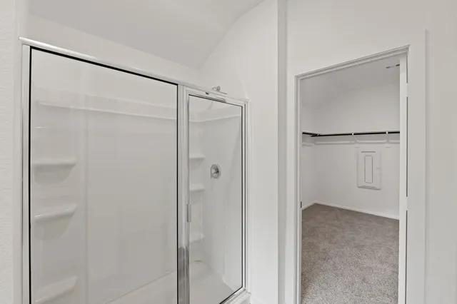 a bathroom with a glass shower door