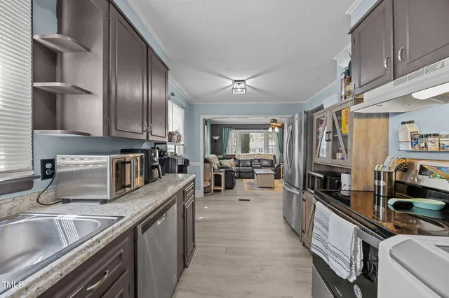 a kitchen with lots of counter top space and stainless steel appliances
