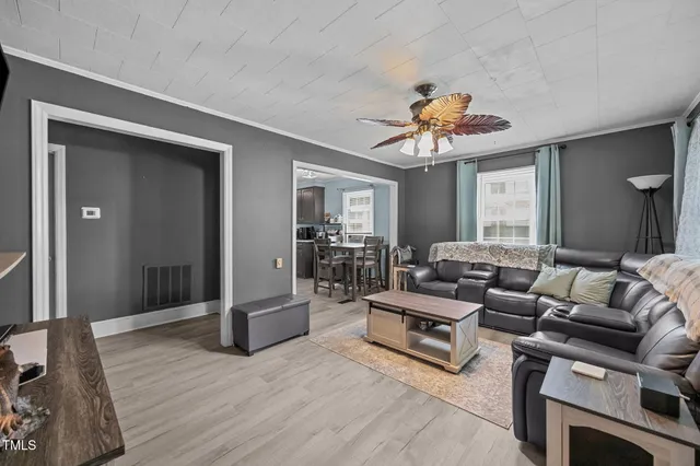 a living room with furniture and a chandelier