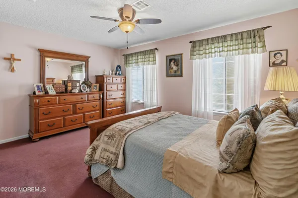 a bed sitting in a bedroom next to a window