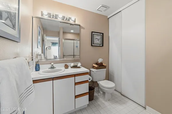 a bathroom with a toilet a sink and a mirror