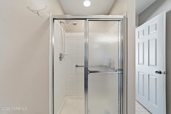 a bathroom with a glass shower door