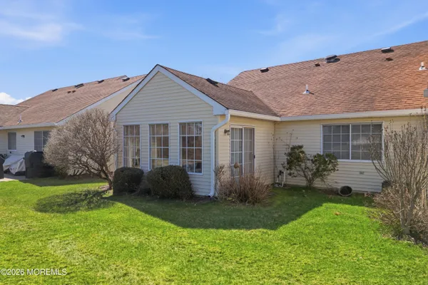 a front view of a house with a garden and yard