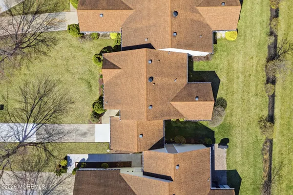 an aerial view of a house with a yard