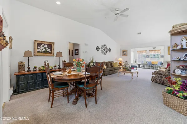 a view of a dining room with furniture and a chandelier
