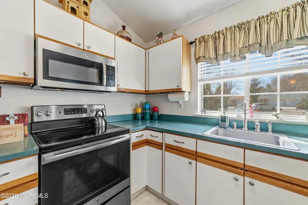 a kitchen with stainless steel appliances a stove sink and microwave