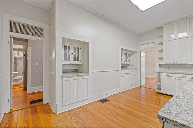 a room with a bed and cabinets