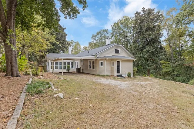 a view of a yard with a house and large tree