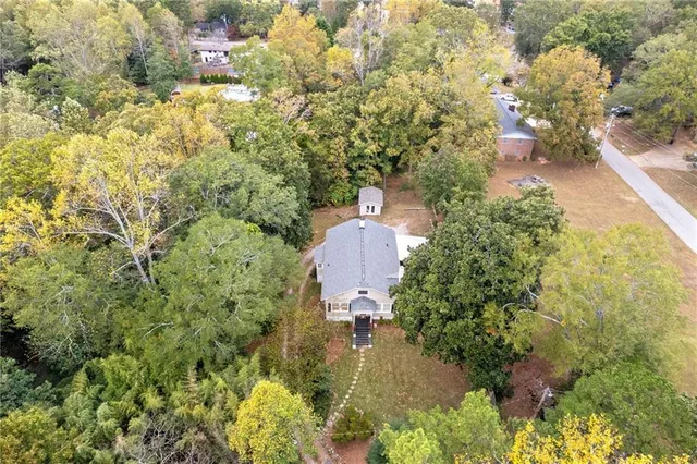 an aerial view of a house with outdoor space and sitting area