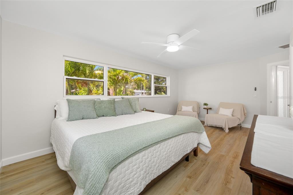 656 Mehlenbacher Road Belleair, FL 33756 - Photo 24 of 49 a bedroom with two beds and a large window