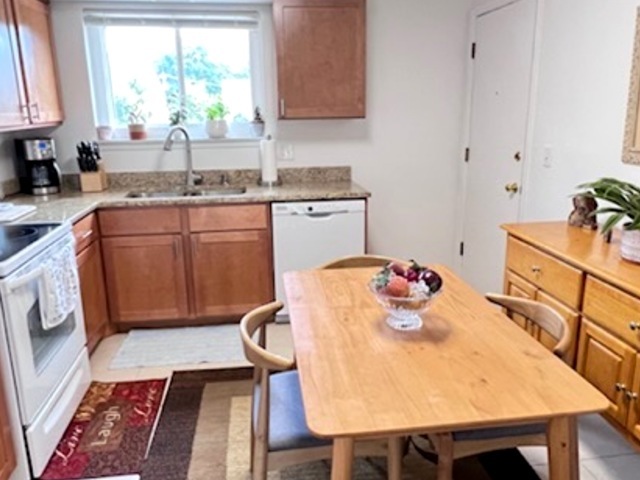920 South Plum Grove Road, Unit 225 Palatine, IL 60067 - Photo 4 of 15 a kitchen with stainless steel appliances granite countertop a sink a stove a dining table and chairs