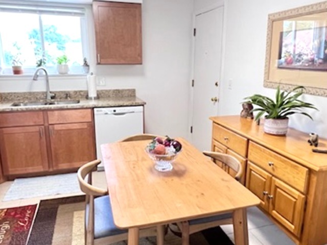 920 South Plum Grove Road, Unit 225 Palatine, IL 60067 - Photo 6 of 15 a kitchen with stainless steel appliances dining table and chairs